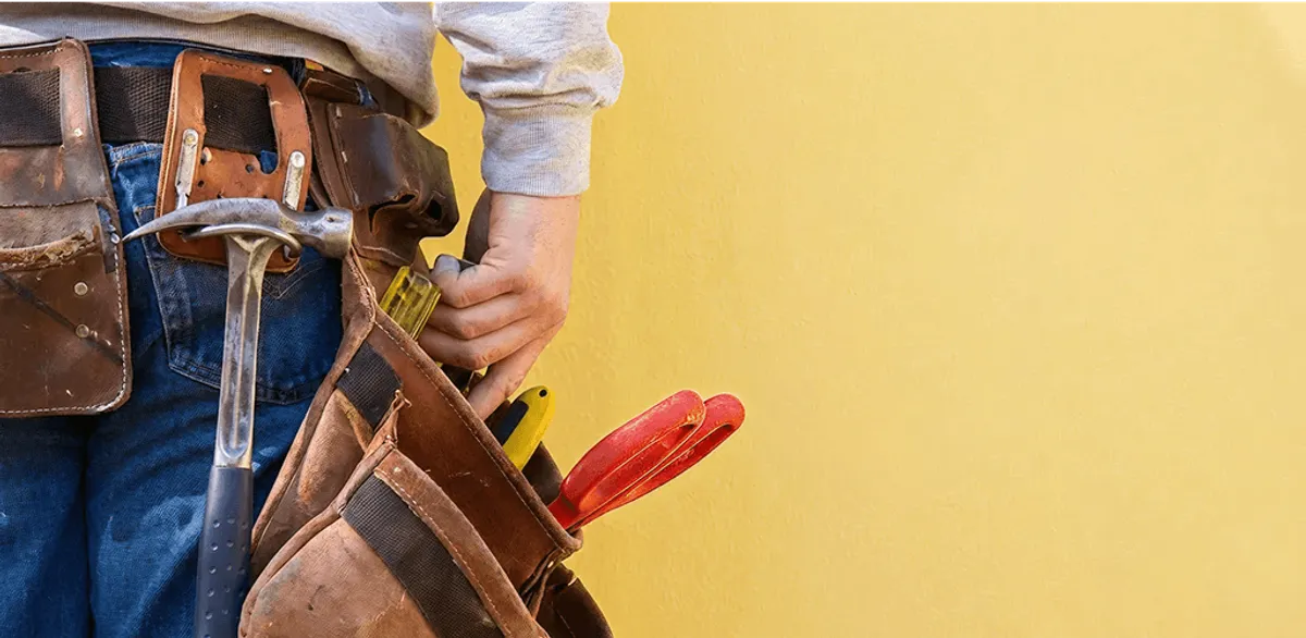 Handyman with tool belt ready for home repairs and maintenance in Jackson, MS