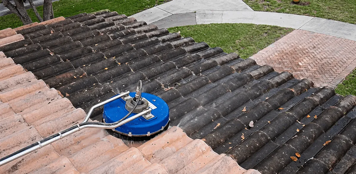 Roof pressure cleaning removing debris and buildup from roof tiles in Jackson, MS