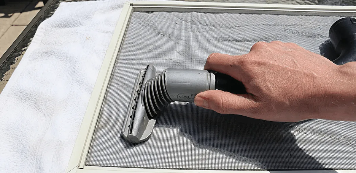 Window screen repair cleaning and fixing a damaged screen mesh in Jackson, MS